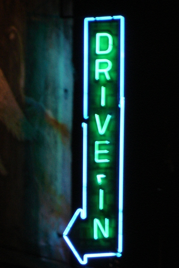 Image: a neon sign reads "Drive In"