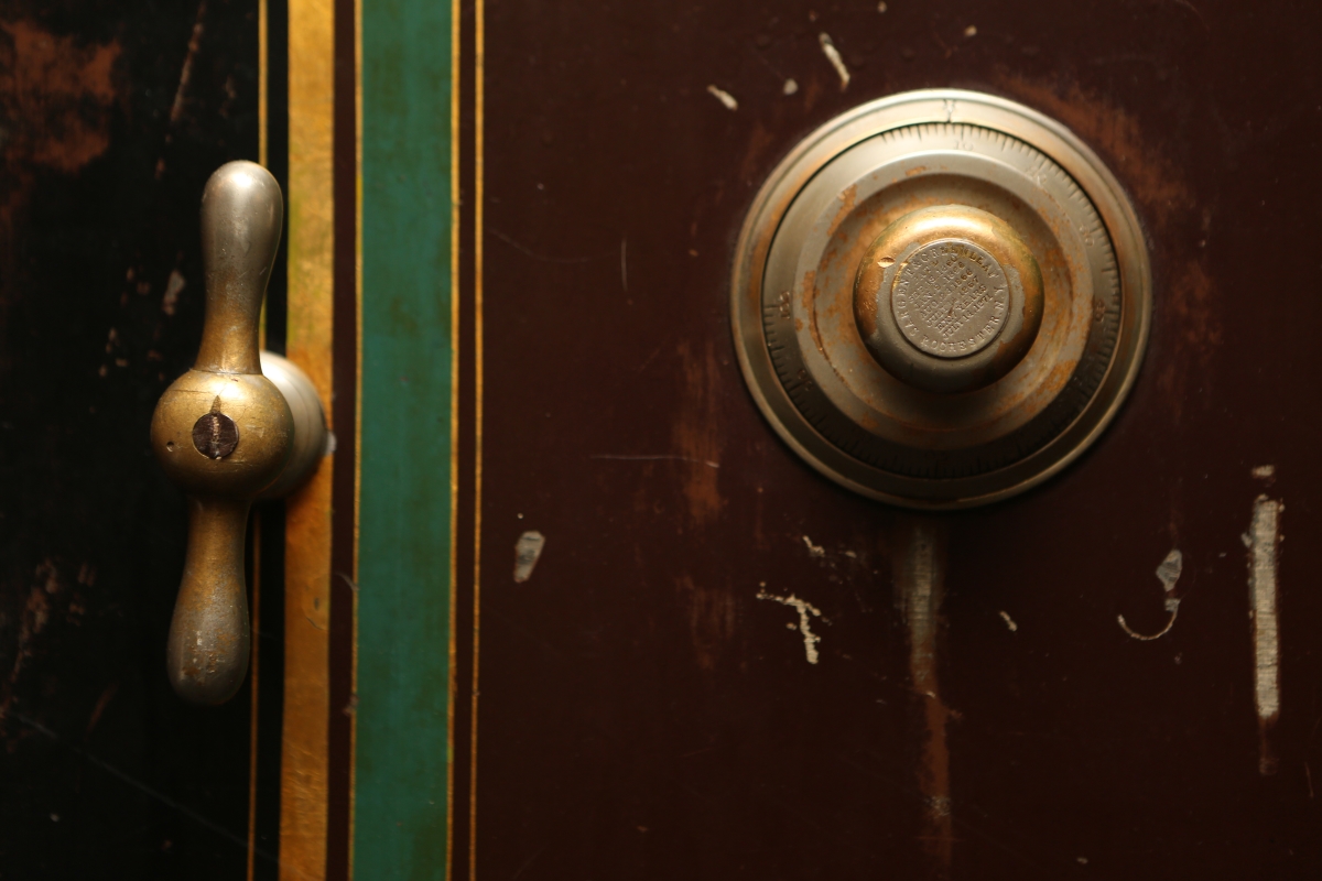 A combination lock guards a wooden door.